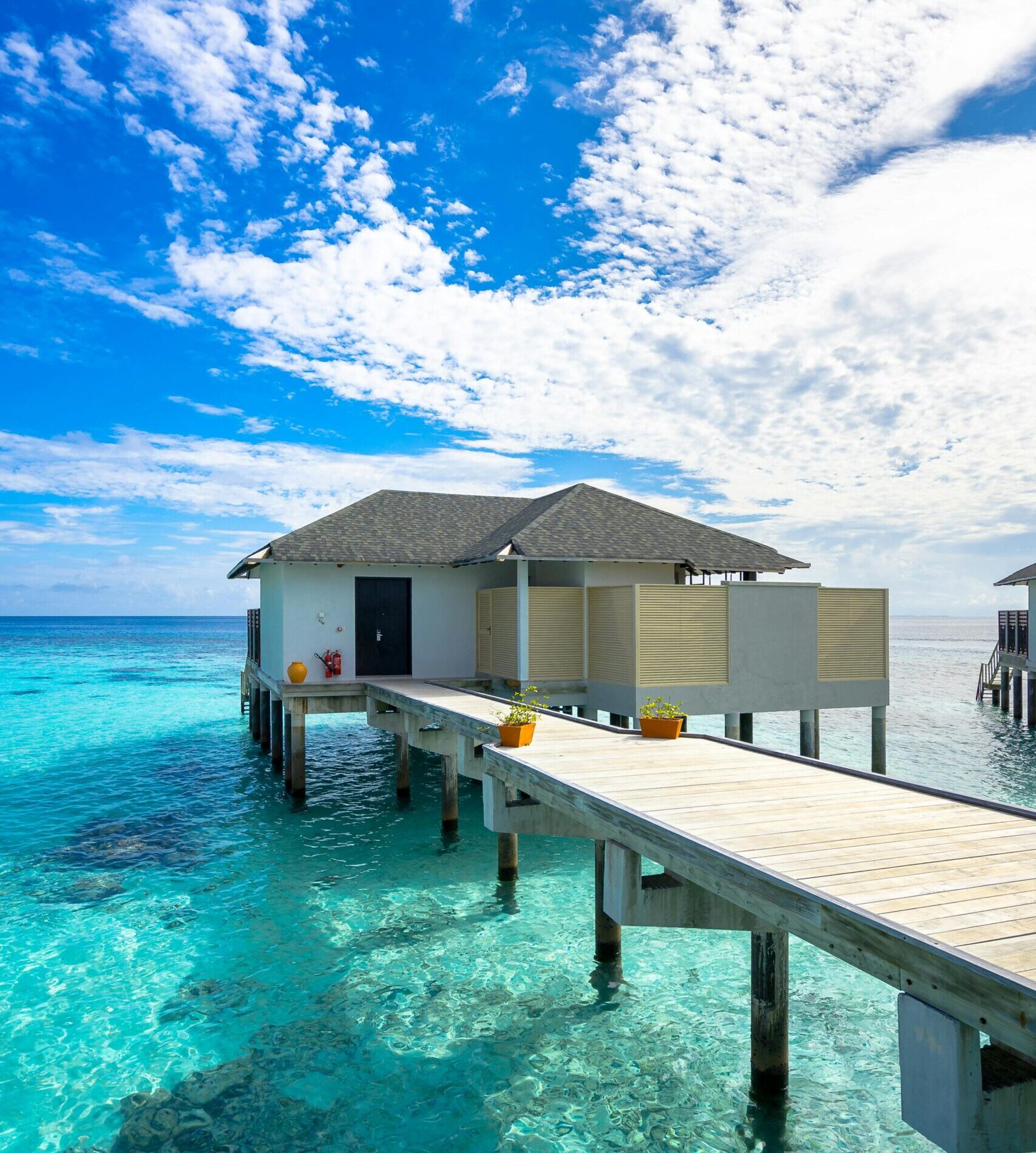 Luxury overwater villa with breathtaking ocean and sky views, ideal for tropical vacations.